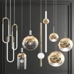 Modern chandelier with suspended gold and glass pendants of various shapes against a dark background.