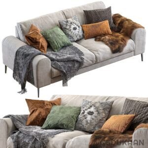 Modern grey sofa with various decorative pillows and a cozy blanket, with a sleeping cat on top