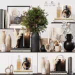 A collection of modern home decor arranged on shelves, featuring books, candles, vases, a potted plant with red berries, and various decorative objects in neutral tones.