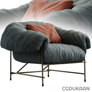 A modern grey armchair with plush cushions and gold metal legs, with additional coral-colored pillow on top