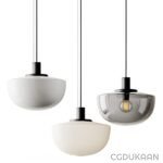 Three modern pendant lights with different glass shades - white, grey, and cream - hanging from black cords against a white background.