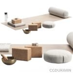 A variety of meditation and yoga accessories including a yoga mat, cork blocks, a singing bowl, and round cushions.