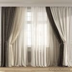 A set of white curtains hanging in front of a window with sunlight shining through the sheer fabric.