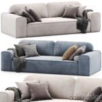 Three couches with pillows and cushions in different colors and patterns, creating a cozy and inviting seating area.