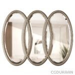 Three oval mirrors hanging on a wall in a room, reflecting the surroundings elegantly.