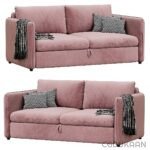 Two pink sofas with pillows and blankets in a cozy living room setting.