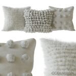 Four decorative pillows with unique designs and patterns, perfect for adding a pop of color to any room.