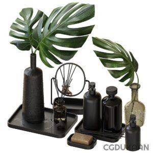 A collection of black vases and green plants on a table.