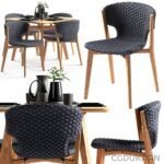 A set of four elegant chairs surrounding a stylish table, creating a cozy dining or gathering space.