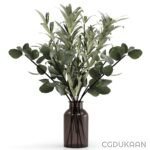 A decorative vase filled with lush green leaves, showcasing a vibrant and natural aesthetic.