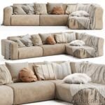 A spacious sectional couch adorned with decorative pillows and cozy blankets, inviting relaxation and comfort.