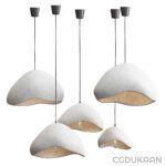 Four pendant lamps featuring elegant white and gray shades, suspended in a stylish arrangement, illuminating the space.