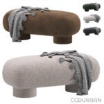 A large ottoman adorned with a cozy blanket and a stylish scarf, creating a warm and inviting atmosphere.